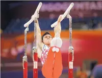  ?? VADIM GHIRDA/ASSOCIATED PRESS ?? Russia’s Artur Dalaloyan performs on the parallel bars en route to winning the world all-around championsh­ip.