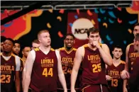  ?? Associated Press ?? ■ Loyola-Chicago's Nick Dinardi (44) and Cameron Krutwig (25) walk to the court for a practice session for the Final Four NCAA college basketball tournament Friday in San Antonio.