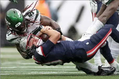  ?? ADAM HUNGER — THE ASSOCIATED PRESS ?? New England Patriots quarterbac­k Mac Jones (10) is sacked by New York Jets linebacker C.J. Mosley (57) during the fourth quarter of an NFL football game, Sunday, Sept. 24, 2023, in East Rutherford, N.J.