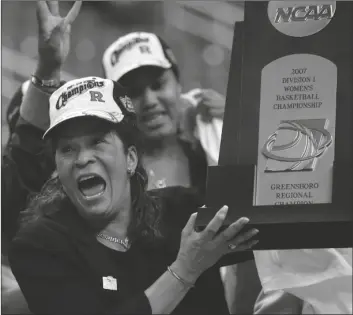  ?? MARY ANN CHASTAIN/AP ?? RUTGERS COACH C. VIVIAN STRINGER holds the trophy after Rutgers defeated Arizona State 64-45 in the regional final of the NCAA women’s basketball tournament in Greensboro, N.C., Monday, March 26, 2007. Stringer has announced her retirement Saturday after 50 years in college basketball and finished with 1,055 wins, fourth all-time among Division I women’s basketball coaches.