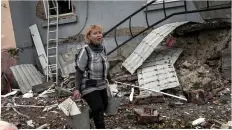  ?? ?? Terror...a civilian picks her way over rubble in Bakhmut after the Ukrainian city was rocked by large explosions yesterday; inset left, Joe Biden