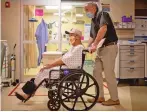  ?? SHARON CHISCHILLY/NEW YORK TIMES ?? Frank Armao, the chief medical officer at the Winslow Indian Health Care Center, with a patient Aug. 25 at the hospital in Winslow, Ariz. Thirty-two COVID-19 patients have died there.