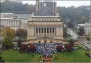  ?? STEPHANIE STRASBURG — PITTSBURGH POST-GAZETTE VIA AP ?? An overflow of people spill out of an interfaith community vigil, Sunday at Soldiers and Sailors Memorial Hall and Museum in Pittsburgh, organized by the Jewish Federation of Greater Pittsburgh, to honor those impacted by the previous day’s mass shooting at Tree of Life Synagogue.