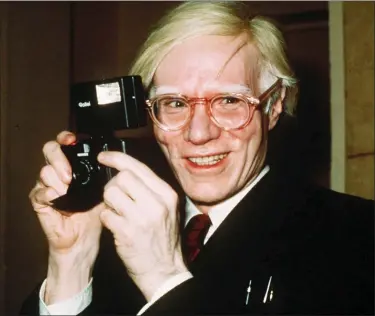  ?? RICHARD DREW — THE ASSOCIATED PRESS FILE ?? Pop artist Andy Warhol holds a camera in New York. A new exhibition titled, “Andy Warhol - From A to B and Back Again,” is running through March 31 at the Whitney Museum of American Art in New York.