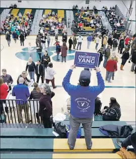  ?? Charlie Neibergall Associated Press ?? A SUPPORTER stands up for Andrew Yang before a Democratic caucus at a high school in Des Moines. There were more than 1,600 caucus sites across Iowa.