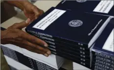  ?? (AP PHOTO/CAROLYN KASTER ?? In this photo taken May 19 a GPO worker stacks copies of “Analytical Perspectiv­es Budget of the U.S. Government Fiscal Year 2018” onto a pallet at the U.S. Government Publishing Office’s (GPO) plant in Washington.