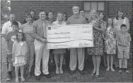  ?? PHOTO SUBMITTED ?? Representa­tives from Shelter Insurance presented a $5,000 check to the Anderson Betterment Club on Friday, June 3. The club won the money when Director Ken Schutten entered an essay contest sponsored by Shelter.