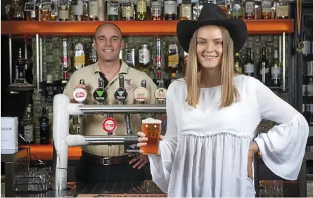  ??  ?? SUPPORT OUR FARMERS: Eliza Gray, from Texas, Qld has a beer with Mick McKeown from the Great Northern brewing Co. The Great Northern Brewing company is donating 1000 kegs to 500 pubs for a drought relief fundraisin­g event.