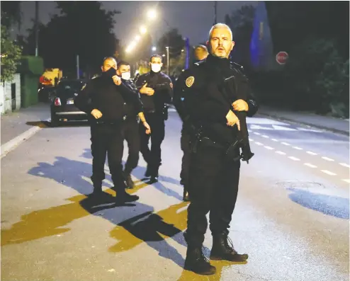  ?? Charles Platia u/ REUTERS ?? Police officers secure the area near the scene of a stabbing attack in the Paris suburb of Conflans St Honorine Friday.