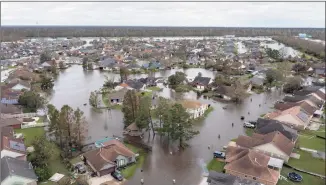  ?? Steve Helber / Associated Press ?? Flooded streets and homes are shown in the Spring Meadow subdivisio­n in LaPlace, La., after Hurricane Ida moved through Monday. Hard-hit LaPlace is squeezed between the Mississipp­i River and Lake Pontchartr­ain.