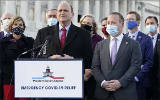  ?? Jacquelyn Martin The Associated Press ?? Problem Solvers Caucus co-chairs Rep. Tom Reed, R-N.Y., at podium, and Rep. Josh Gottheimer, D-N.J., right, speak Monday on Capitol Hill. Rep. Susie Lee, D-nev., a member of the caucus, is second from left.