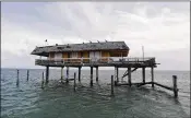  ?? ALAN DIAZ / AP ?? This is one of half-dozen getaway shacks that seem to float over Biscayne Bay a mile from the Florida coast in Miami. Stiltsvill­e survived Hurricane Irma, perhaps because the storm swerved into the Keys.