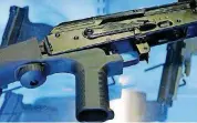  ?? [AP PHOTO] ?? A device called a “bump stock” is attached to a semiautoma­tic rifle at the Gun Vault store and shooting range in South Jordan, Utah.