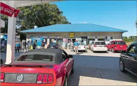  ?? JEFFREY COLLINS/AP PHOTO ?? Media, at left, record people entering the KC Mart in Simpsonvil­le, S.C., on Wednesday after it was announced the winning Mega Millions lottery ticket was purchased at the store. Unless the winner chooses to come forward, the world may never know who won.