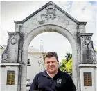  ?? ?? NZ Remembranc­e Army founder Simon Strombom in front of New Plymouth Boys’ High School’s memorial gates.