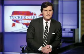  ?? RICHARD DREW — THE ASSOCIATED PRESS FILE ?? In this file photo, Tucker Carlson, host of “Tucker Carlson Tonight,” poses for photos in a Fox News Channel studio, in New York.