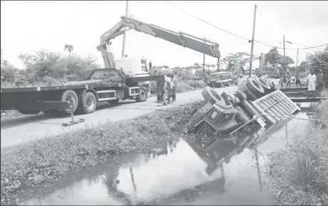  ?? Stabroek News ?? This truck bearing licence plate number GPP 2299, ended up in a Princes Street trench yesterday, damaging a pipe, and disrupting the flow of water to residents in the process. The driver told that he had swerved to avoid a car that had been approachin­g...