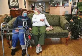  ?? Julie Bennett / Associated Press ?? Carmela Sileo, left, and Susan McEachern talk in the reopened dayroom Wednesday at Arbor Springs Health and Rehabilita­tion Center in Opelika, Ala.