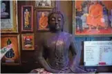  ??  ?? A Buddha wrought from recycled metal at Ban Hun Lek.