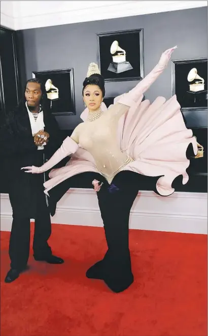  ?? Photograph­s by Marcus Yam Los Angeles Times ?? CARDI B arrives at the Grammy Awards in a 1995-era Thierry Mugler dress that was one of the night’s pink outfits.