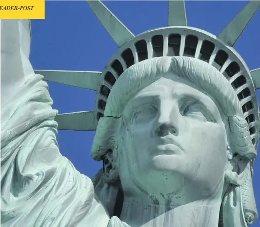  ?? TIMOTHY CLARY / AFP / GETTY IMAGES ?? The Statue of Liberty has been interprete­d as a welcome to immigrants, though that was not its original symbolic purpose.