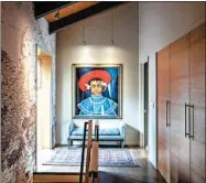  ??  ?? At the top of the main staircase, above Travis Penn’s grandmothe­r’s settee, hangs a painting titled “Millie.”