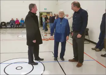  ?? NEWS PHOTO GILLIAN SLADE ?? People enjoy indoor curling, in what used to be the cafeteria, at the newly renovated Strathcona Centre on Wednesday afternoon's open house. In the foreground discussing the improvemen­ts are Mayor Ted Clugston, LaVerne Noble, chair of the Senior Citizens Advisory Committee and Varley Wiseman, administra­tion project manager, community developmen­t with the city.