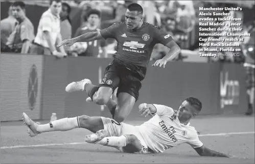  ??  ?? Manchester United’s Alexis Sanchez evades a tackle from Real Madrid’s Javier Sanchez during their Internatio­nal Champions Cup friendly match at Hard Rock Stadium in Miami, Florida on Tuesday.