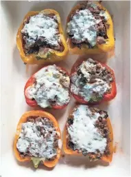  ?? SCHAMBERG ANNE ?? Stuffed peppers can be made and baked right away or frozen for serving later in the week.