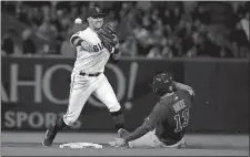  ?? JEFF CHIU/AP PHOTO ?? San Francisco Giants second baseman Joe Panik, left, throws to first base after forcing Chicago Cubs’ David Bote at second base on a double play hit by Addison Russell during a game on July 23.