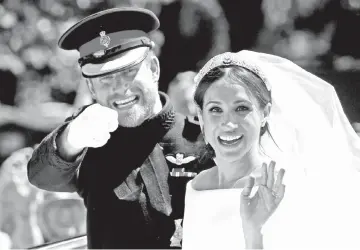  ?? — Reuters file photo ?? Prince Harry gestures next to his wife Meghan as they ride a horse-drawn carriage after their wedding ceremony at St George’s Chapel in Windsor Castle in Windsor, Britain, last May 19.