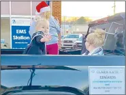  ?? (Courtesy Photo/Mallory Weaver) ?? Clara Kate Edwards, winner of the titles 2020 Miss Boston Mountains and 2020 Miss Benton County Tiny Tot, waves to the crowd in the Gravette Christmas parade. Several other area beauty queens joined her for the event.