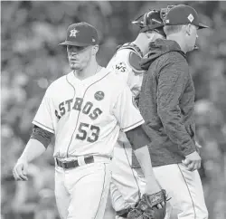  ??  ?? Giles, left, exits Game 4 of last fall’s World Series. It proved to be his final appearance of an abysmal postseason in which he admittedly wore out.