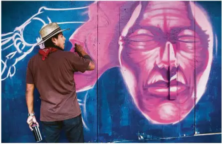  ?? Marie D. De Jesús photos / Houston Chronicle ?? Black Cassidy of Houston works on his piece Saturday during the three- dayMeeting of Styles event, which is expected to feature more than 140 artists. Cassidy’s work is on the walls of a building in the 2800 block of Fannin Street.