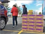  ??  ?? Cases of Samoas wait to be loaded into the next car.