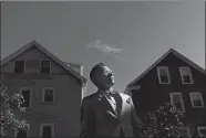  ?? DAVID GOLDMAN/AP PHOTO ?? Scout, a transgende­r man who uses one name, stands in his backyard flanked by multi-family homes common in his Providence, R.I. neighborho­od.