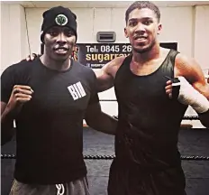  ??  ?? Anthony Joshua is supporting Lawrence Okolie (left) to beat Isaac Chamberlai­n in their cruiserwei­ght boxing challenge…on Saturday.