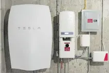  ?? BLOOMBERG ?? Tesla’s Powerwall unit can store electricit­y generated by the company’s new solar roof shingles systems to provide your home with backup power in the case of a convention­al outage.