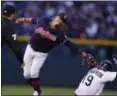  ?? DAVID ZALUBOWSKI — ASSOCIATED PRESS ?? Umpire D.J. Rayburn looks on as Francisco Lindor reaches down to make a late tag on the Rockies’ Charlie Blackmon as he steals second.