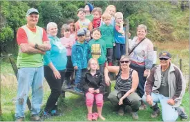  ??  ?? Papatawa Junior School on the stile with adults James Kendrick and Morrie Black (Ngati Kahungunu), Teresa De Vries (parent helper — left), Lanette Lawrence (teacher — right), Kate McArthur (fresh water specialist — squatting).