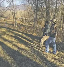  ?? BY TORNEY VAN ACKER ?? Josh Turner and Bradlee Ritchie of Racey Engineerin­g assess the potential routing of the proposed accessible pedestrian path.