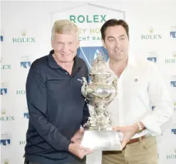  ??  ?? SYDNEY: Rolex Sydney to Hobart yacht race 2015 winner Paul Clitheroe, owner/skipper of Balance, and Mark Richards, skipper Wild Oats XI pose with the trophy at the Cruising Yacht Club of Australia in Sydney yesterday. Australia’s grueling Sydney to...