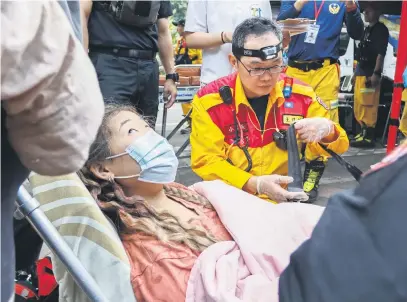  ?? Picture: EPA-EFE ?? HIGH CARE. A woman receives medical attention after being rescued from Taroko National Park, following a 7.4-magnitude earthquake, in Hualien, Taiwan, on Thursday.