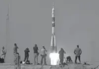  ?? Associated Press ?? The SoyuzFG rocket booster with Soyuz MS-09 space ship carrying a new crew to the Internatio­nal Space Station, ISS, blasts off Wednesday in Baikonur, Kazakhstan.