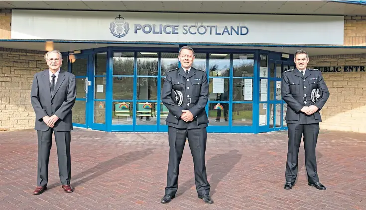  ??  ?? LONG LINE OF DUTY: Former chief superinten­dent Ronnie Mcewan with sons Garry, a national commander, and Derek, a divisional commander, outside Glenrothes Police HQ.
