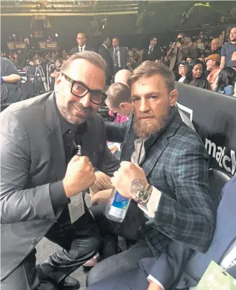  ?? PHOTO COURTESY OF REGAN COMMUNICAT­IONS ?? Strega owner Nick Varano poses with UFC fighter Conor McGregor ringside at TD Garden.