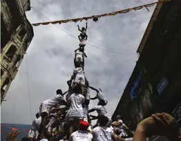  ?? — AP ?? A group of youth form a human pyramid to break the ‘ Dahi Handi’ as part of celebratio­ns to mark Janmashtam­i in Mumbai on Monday.