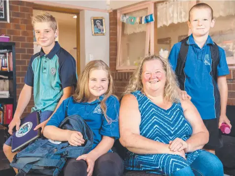  ?? Picture: JASON EDWARDS ?? COSTLY LESSONS: Carol Achison-Mills with her kids, from left, Lachlann, 13, Mykaylah, 12, and Harley, 10. Nearly two-thirds of families surveyed said the cost of sending their kids to school is "unaffordab­le".