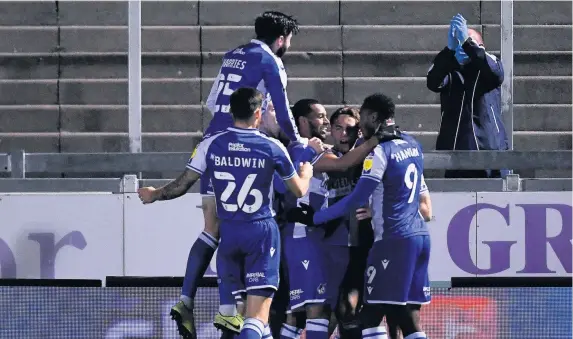  ?? Pictures: Ryan Hiscott/JMP ?? Rovers players rush to congratula­te James Daly, second right, on his goal against Hull at the Memorial Stadium