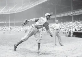  ?? MATTY ZIMMERMAN/AP ?? In this 1942 file photo, Kansas City Monarchs pitcher Leroy Satchel Paige warms up at Yankee Stadium before a Negro League game.